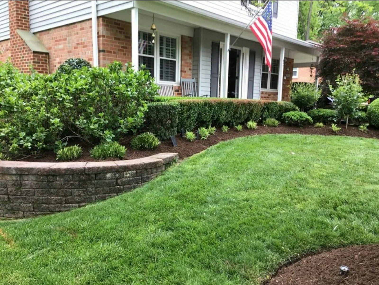 Clean, weed-free landscape beds along a green front lawn